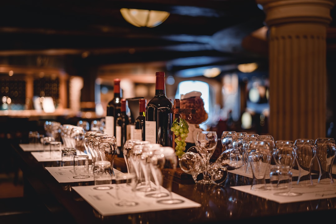 closeup photo of wine bottle and wine glasses on table