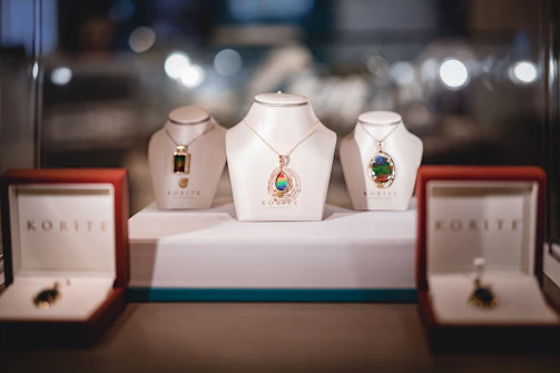several assorted-color necklaces with pendants and boxes