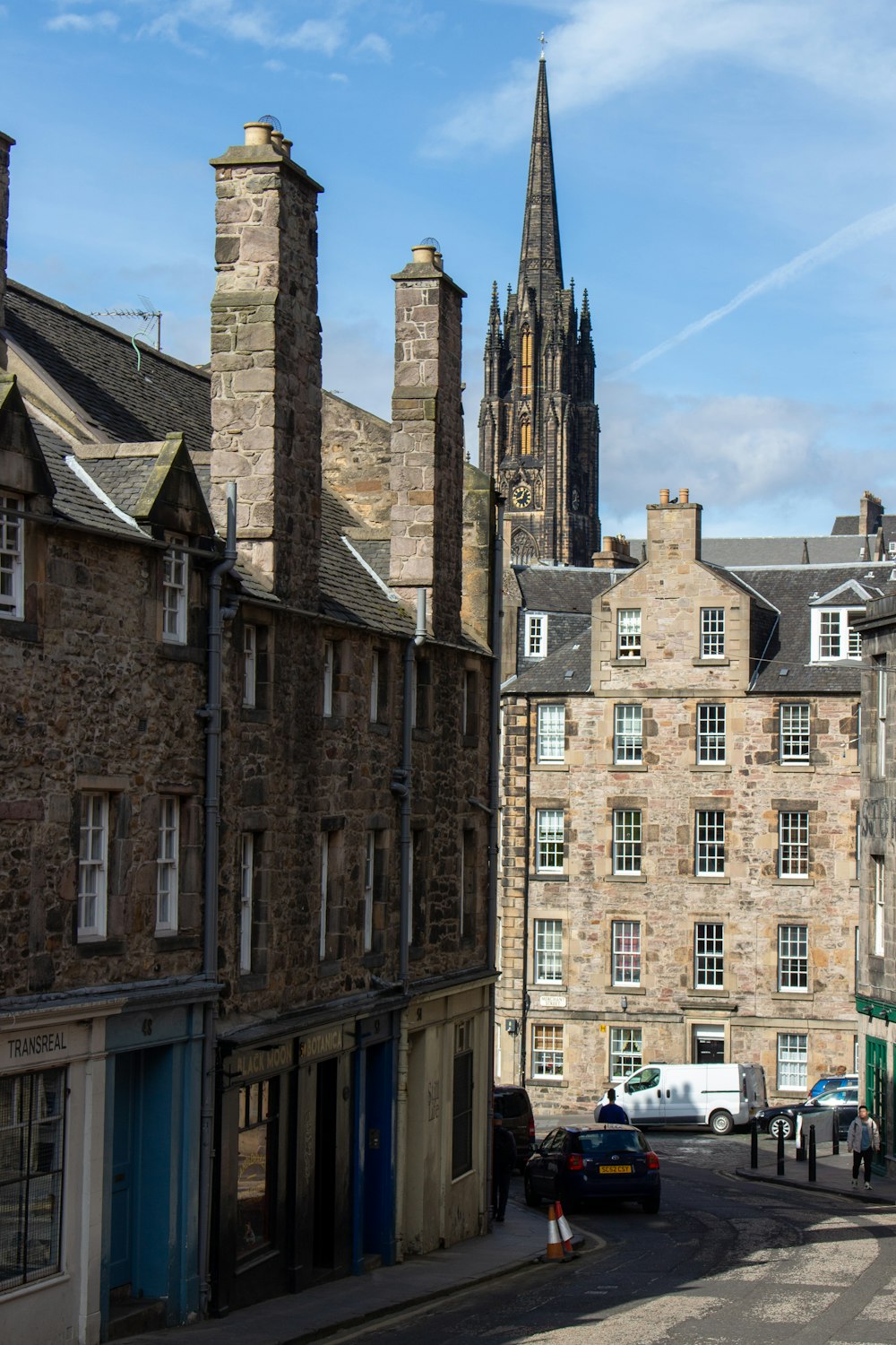 cars passing by the streets near a cathedral