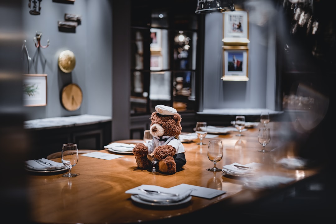 bear plush toy on dining table beside tableware