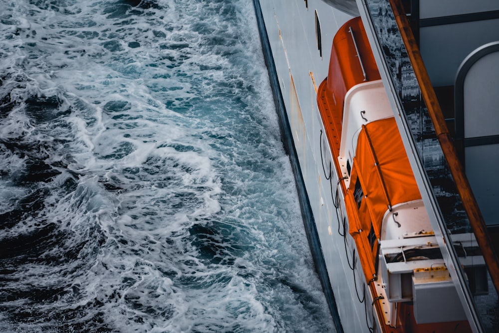 white and orange boat photograph