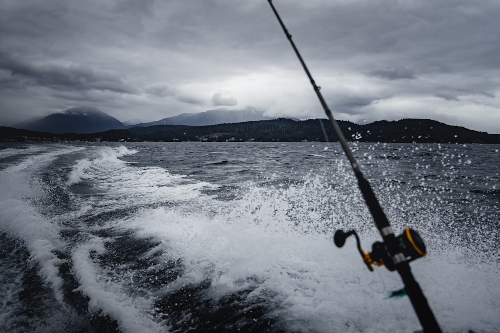 shallow focus photo of black fishing rod