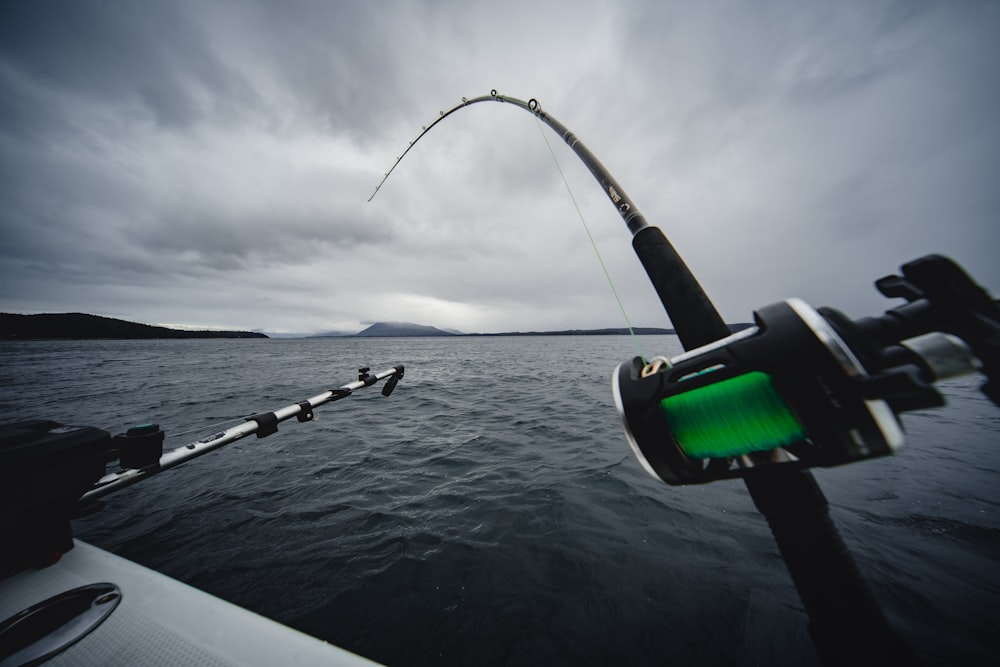 closeup photo of black and green fishing rod
