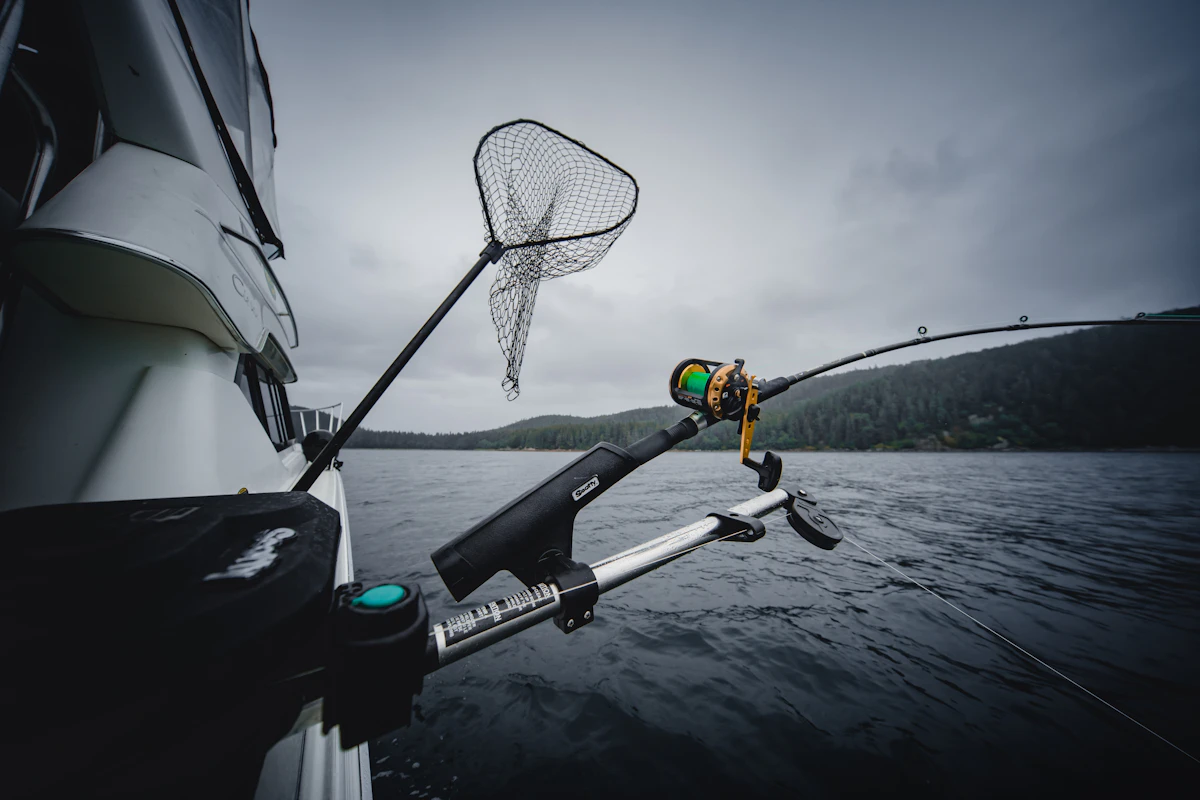 Fishing rod and net hanging from a boat in the sea
