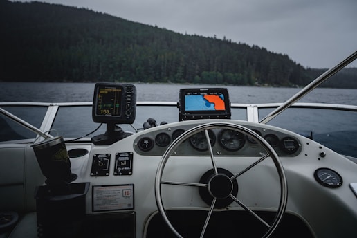 two black fish finders on a fishing boat