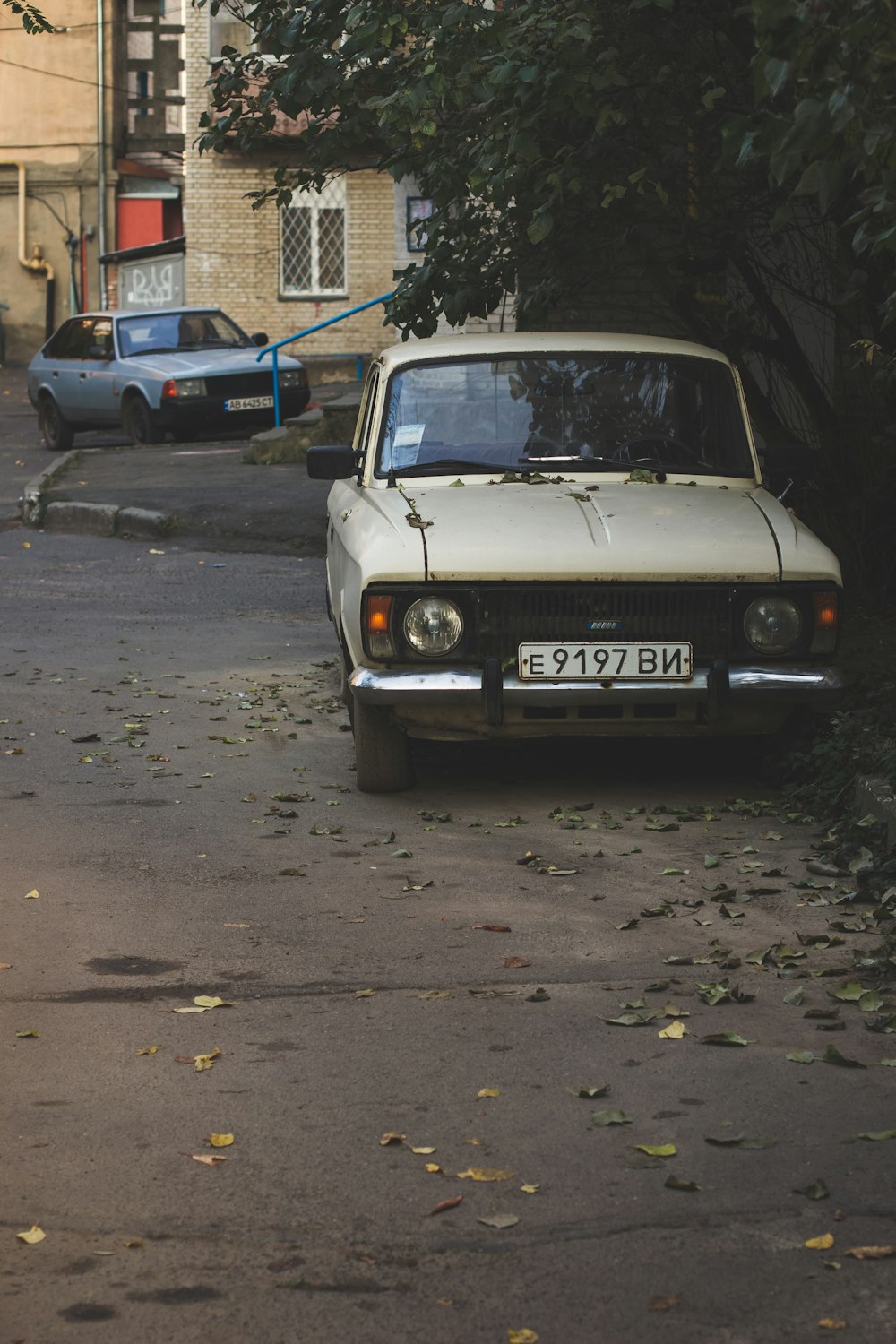 white car parked on the side of a street