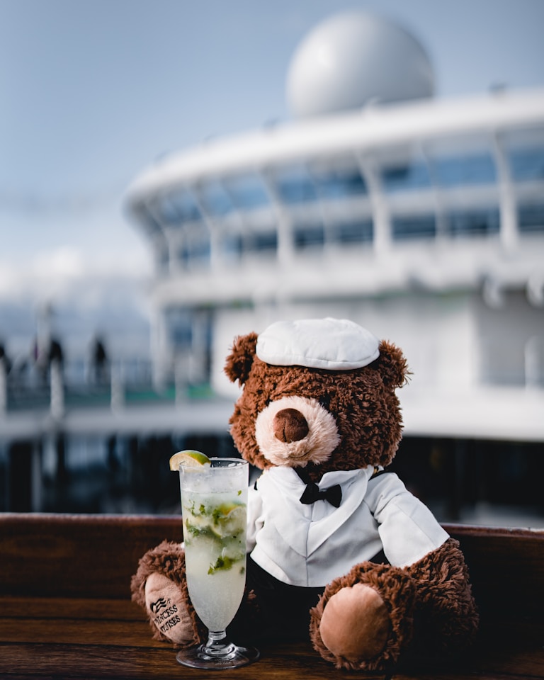 teddy bear beside the wine glass