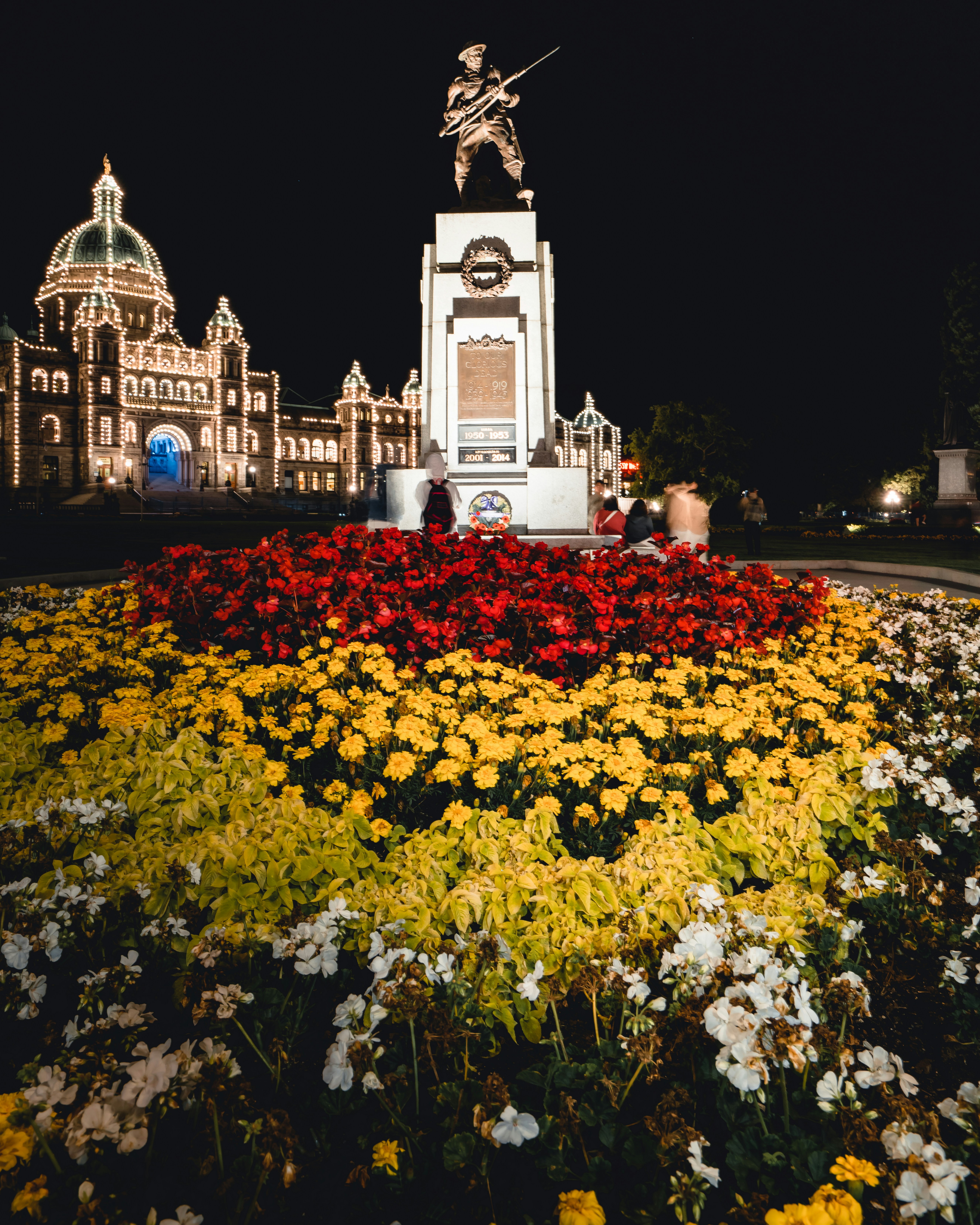 red and yellow flower field in front of the statue