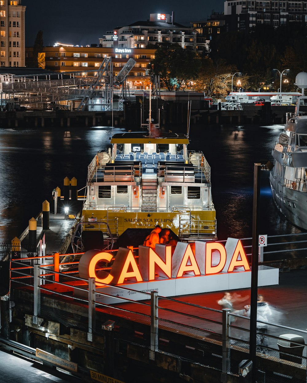 white and yellow yacht on the body of water