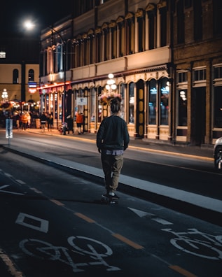 An evening scene of riders celebrating after a local streetboard event under city lights.