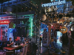 A lively honky tonk bar in Texas with a small stage and colorful string lights.