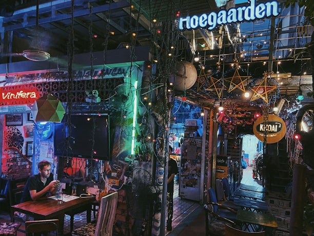 A lively honky tonk bar in Texas with a small stage and colorful string lights.
