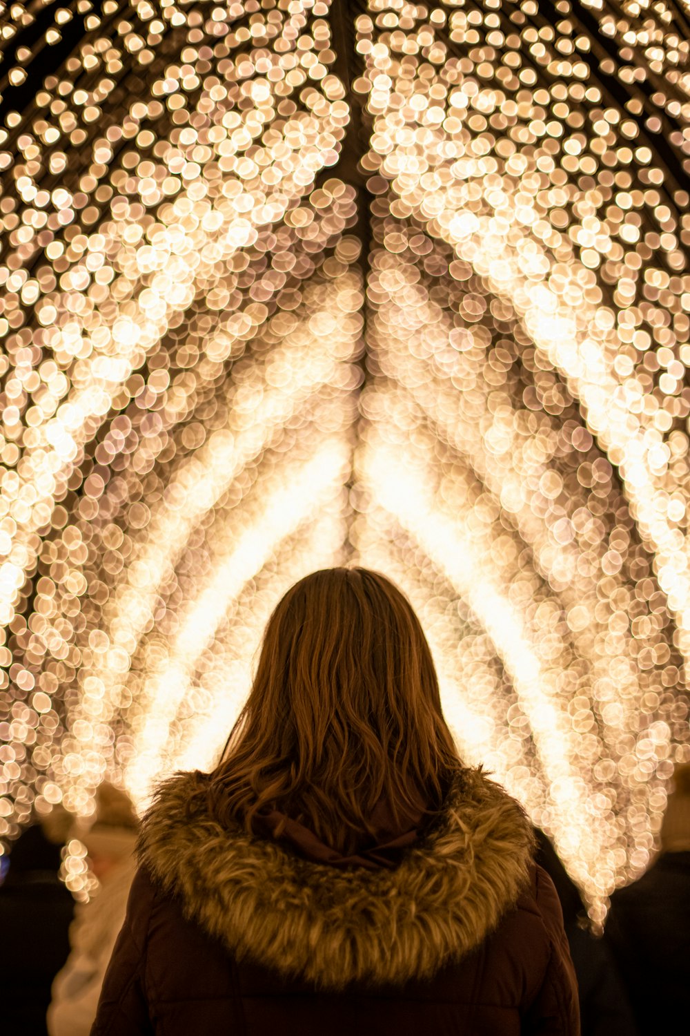woman under tunnel of lights