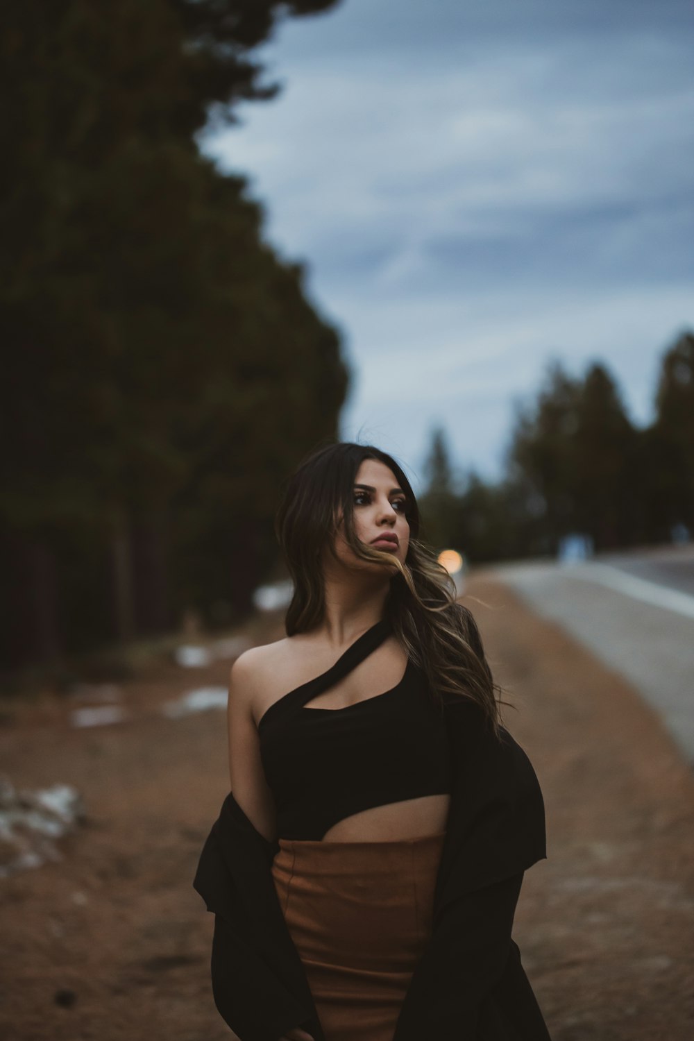 woman in black crop top and brown outfit by trees during daytime