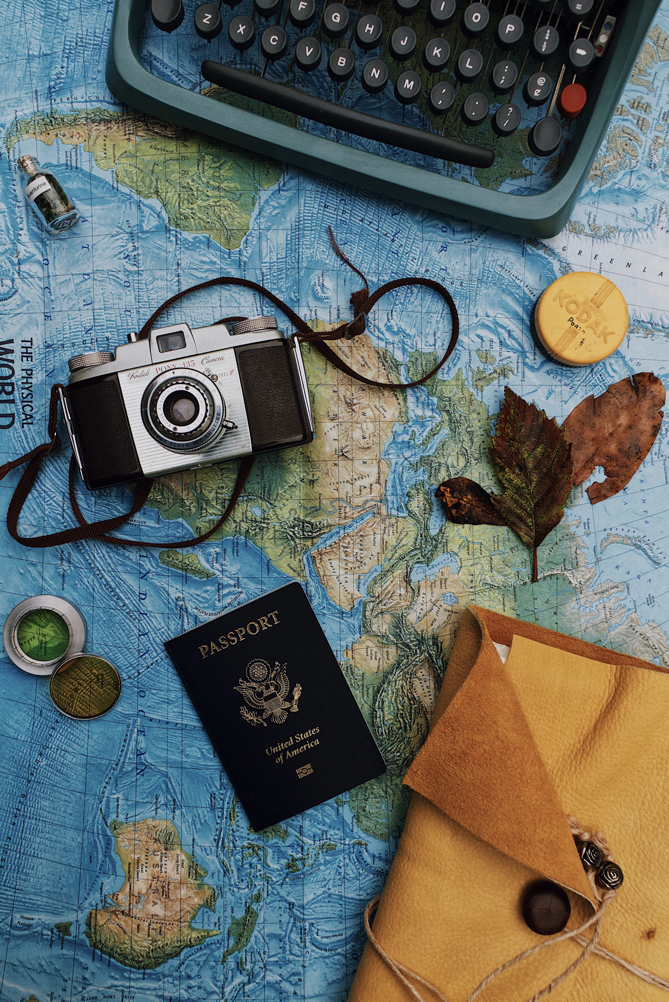 A passport and travel documents laid out on a map, ready for a visa application