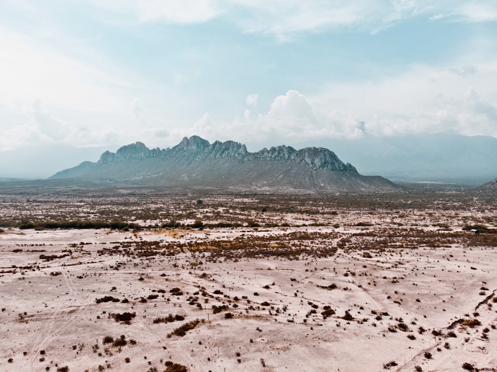 gray mountain under cloudy sky during daytime