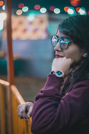 selective focus photography of woman leaning on fence