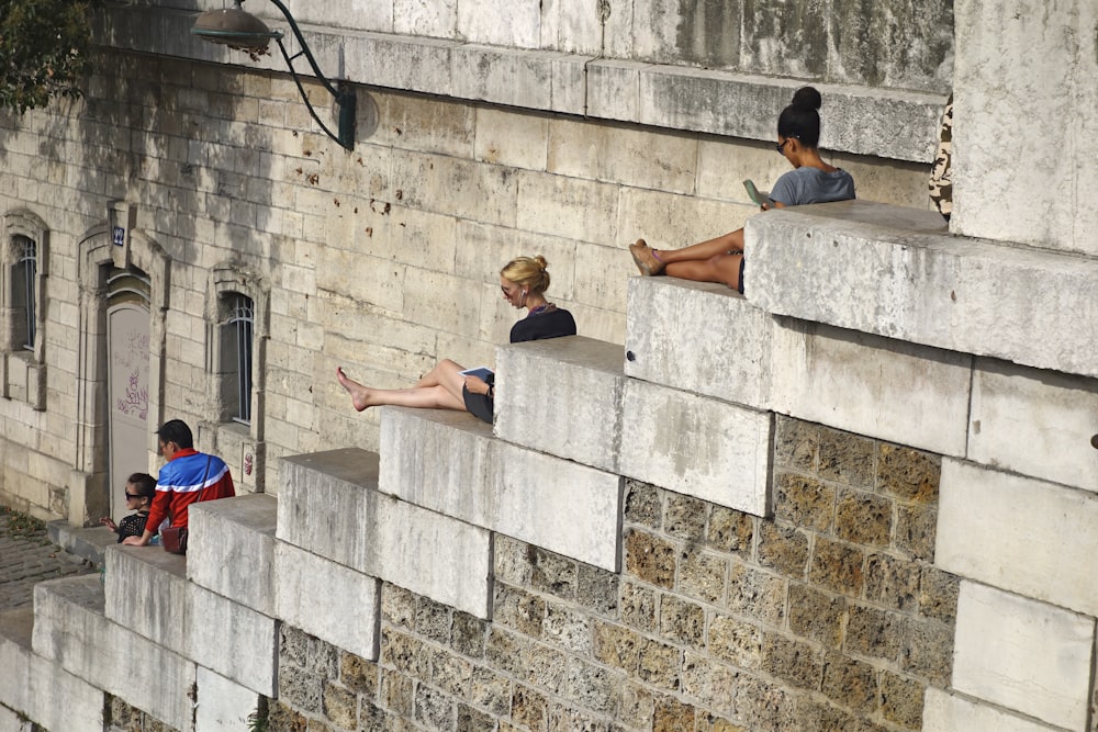 a group of people sitting on top of cement blocks