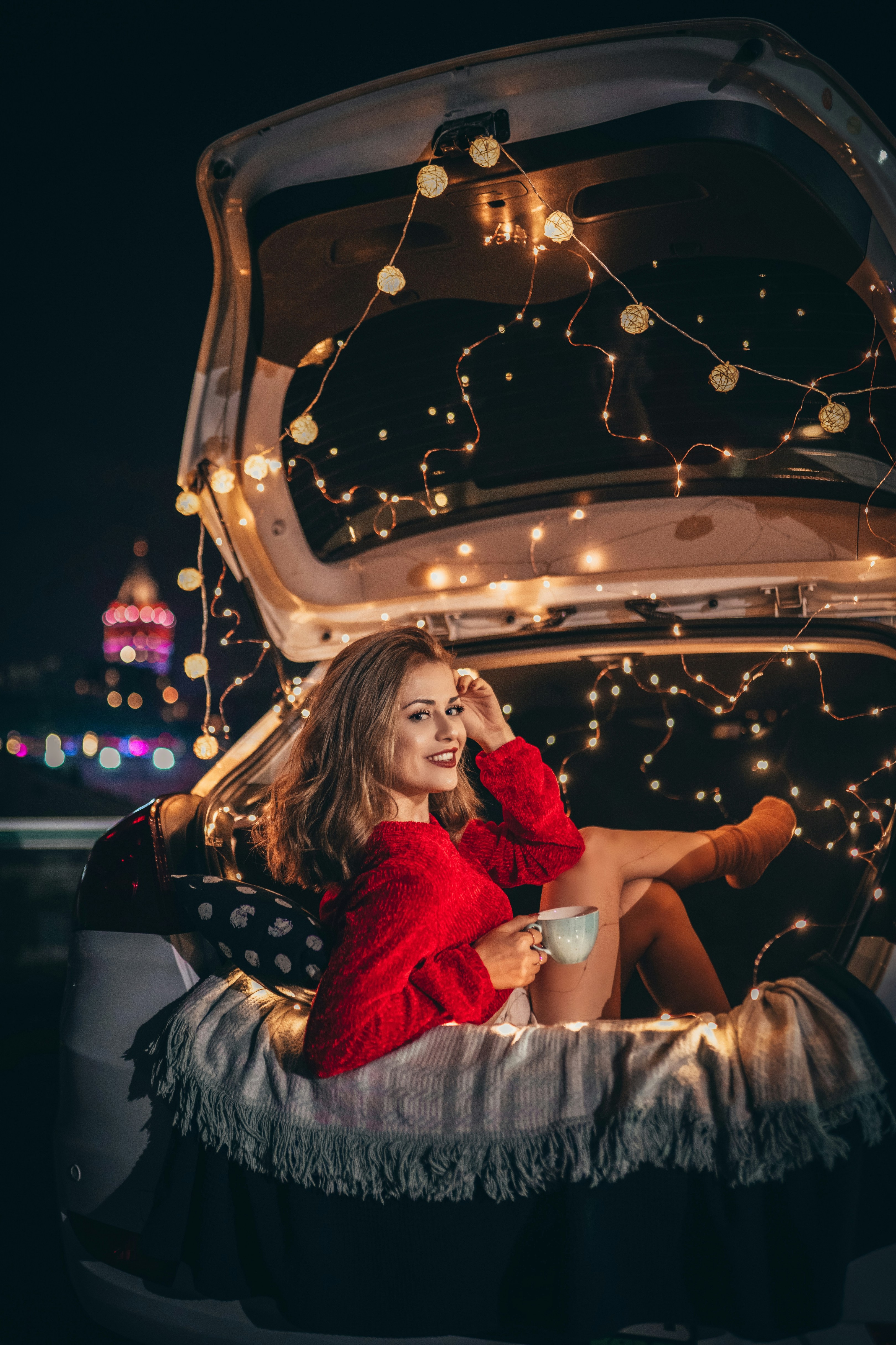 Woman sitting on vehicle truck