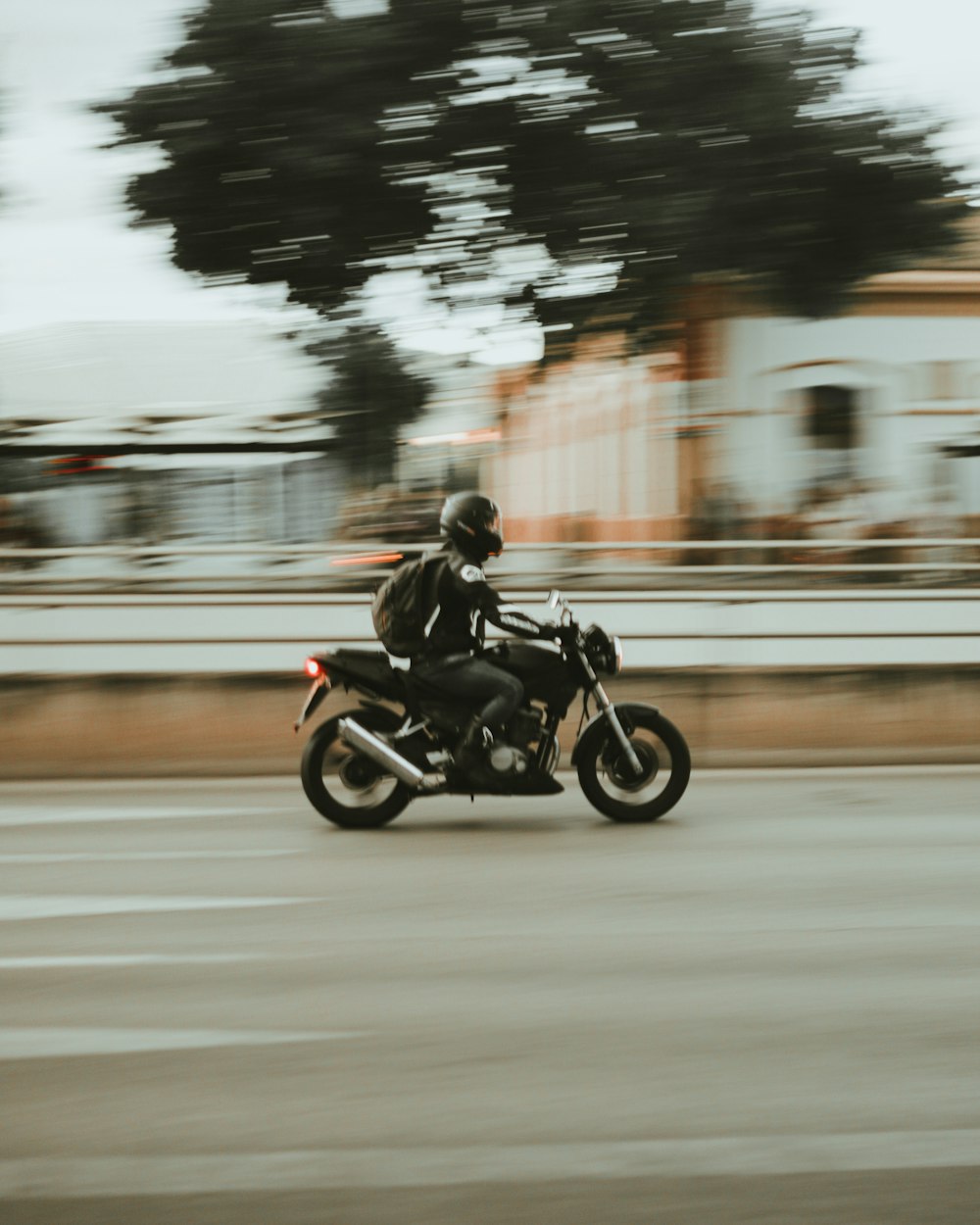 a man riding a motorcycle down a street