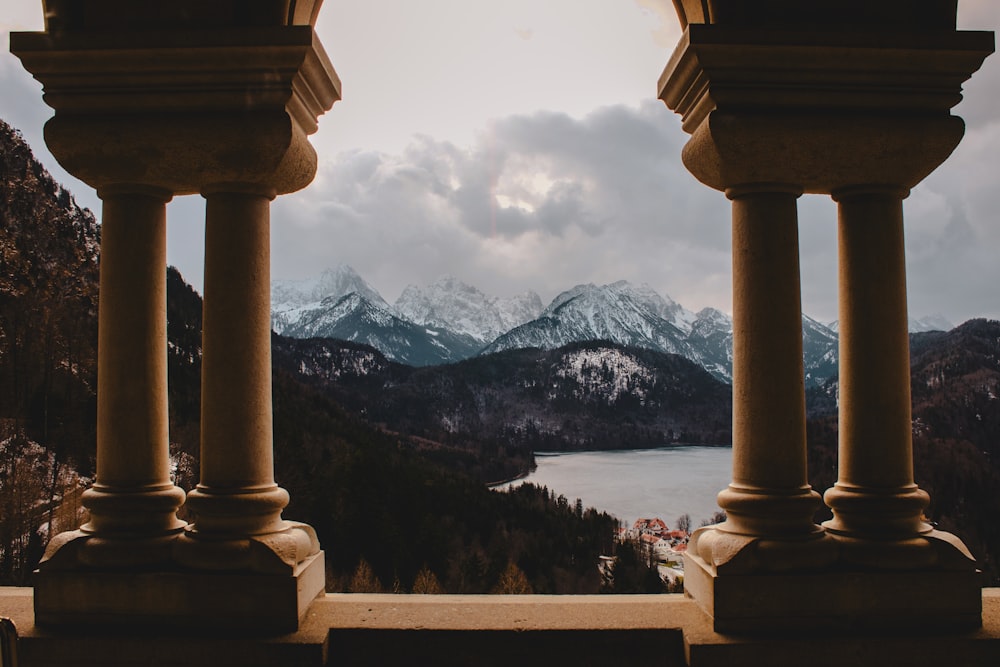 terrace overlooking body of water under cloudy sky during daytime