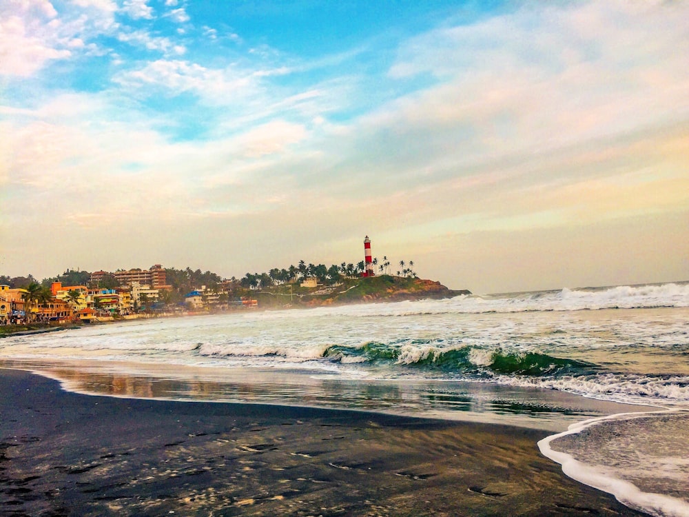 a view of a beach with a lighthouse in the distance