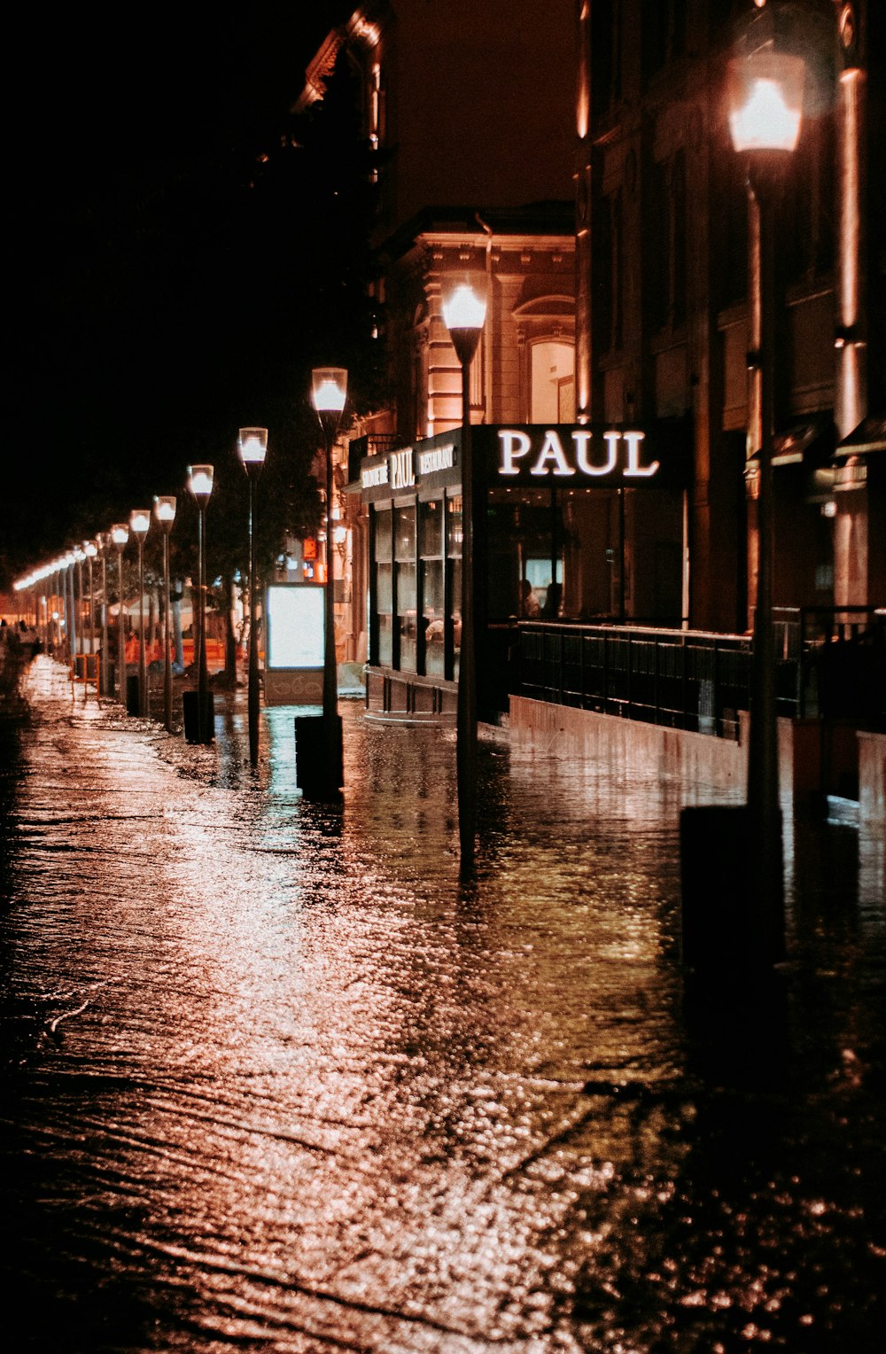 a city street is flooded with water at night