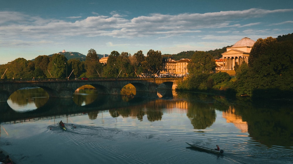 a couple of boats floating on top of a river