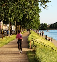 An outdoor shot of a person jogging happily along a tree-lined path, symbolizing regained freedom of movement.