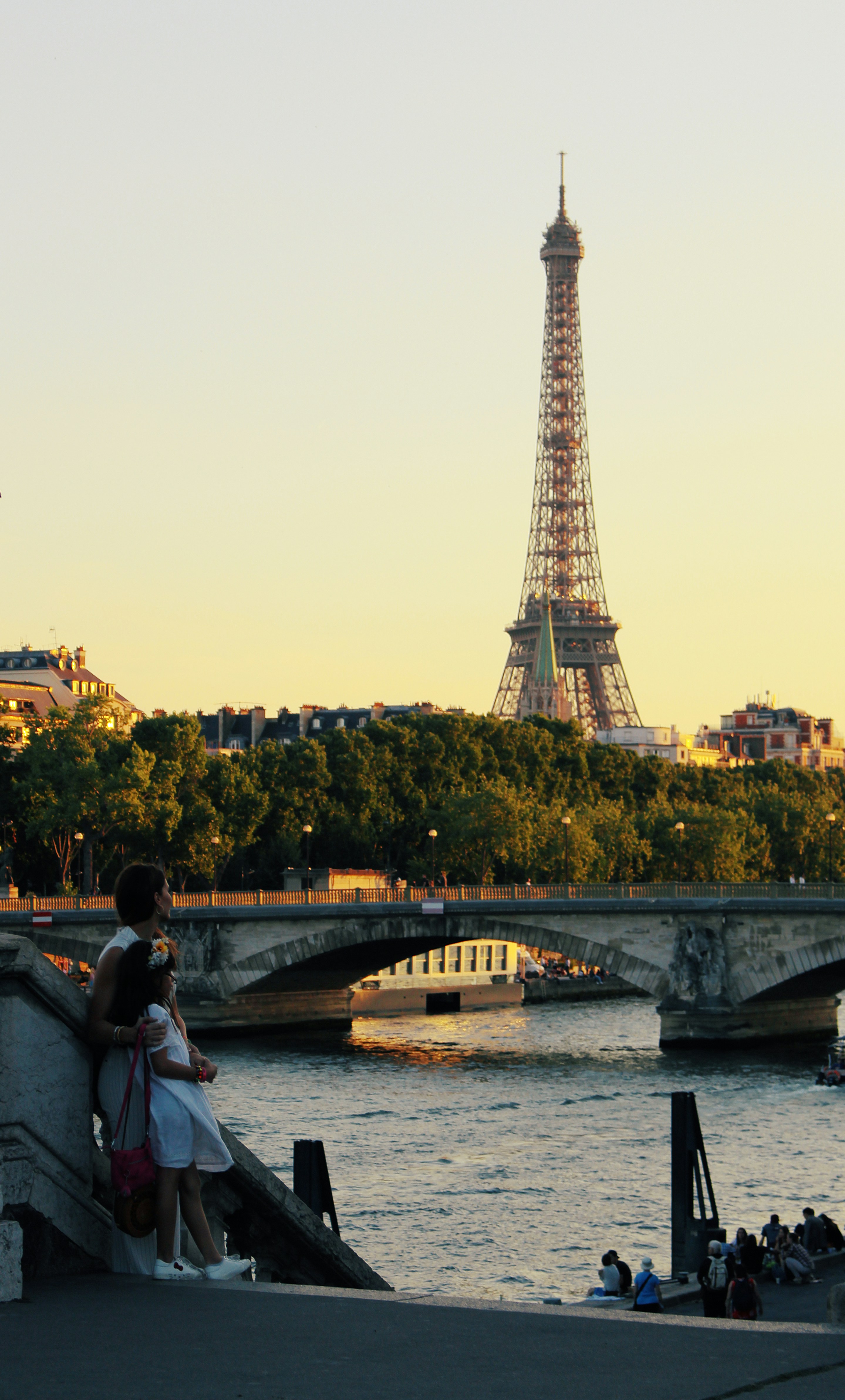 people standing near body of water overlooking Eiffel Tower