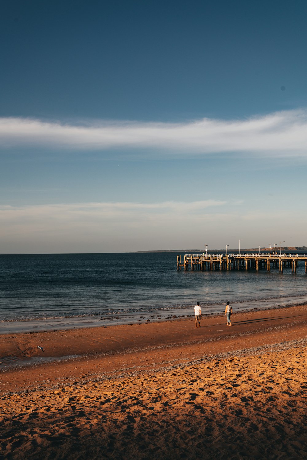 man and woman standing on shore