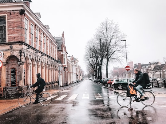 men on bikes on road in Groningen Netherlands