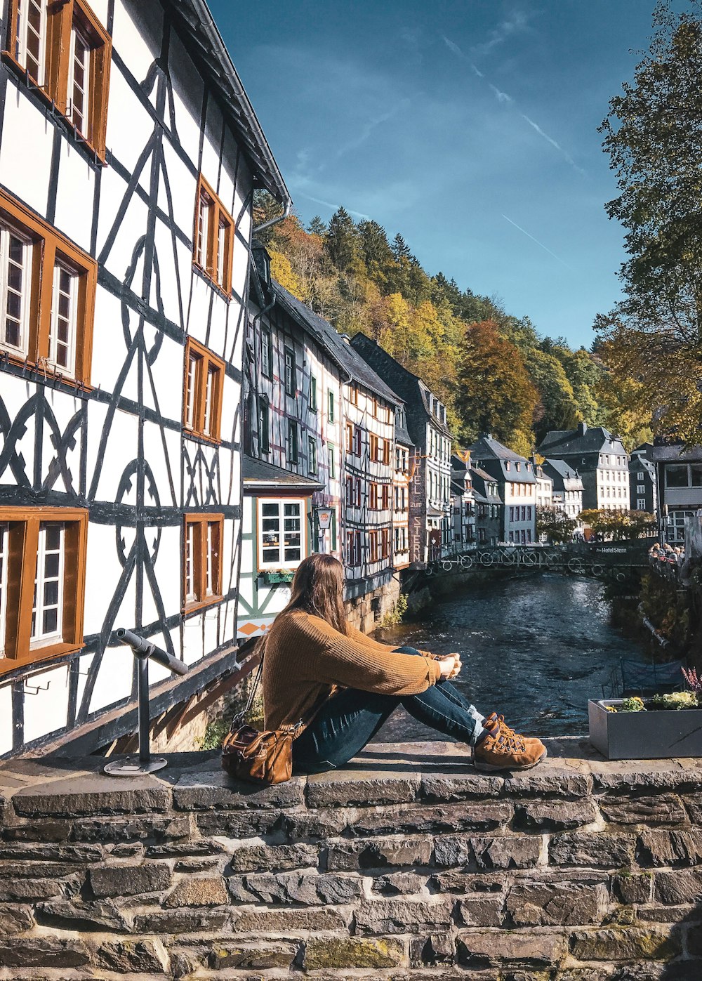 woman sitting on bridge