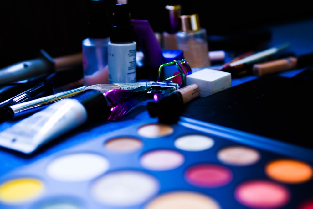 a close up of a table with makeup and brushes