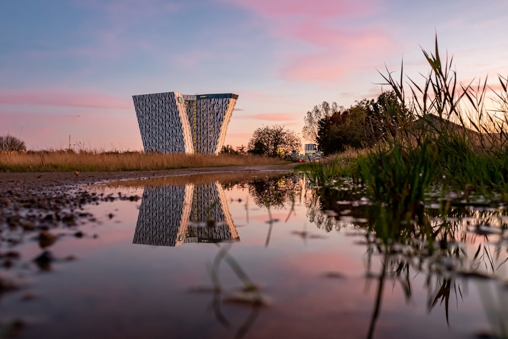 a body of water with a building in the background