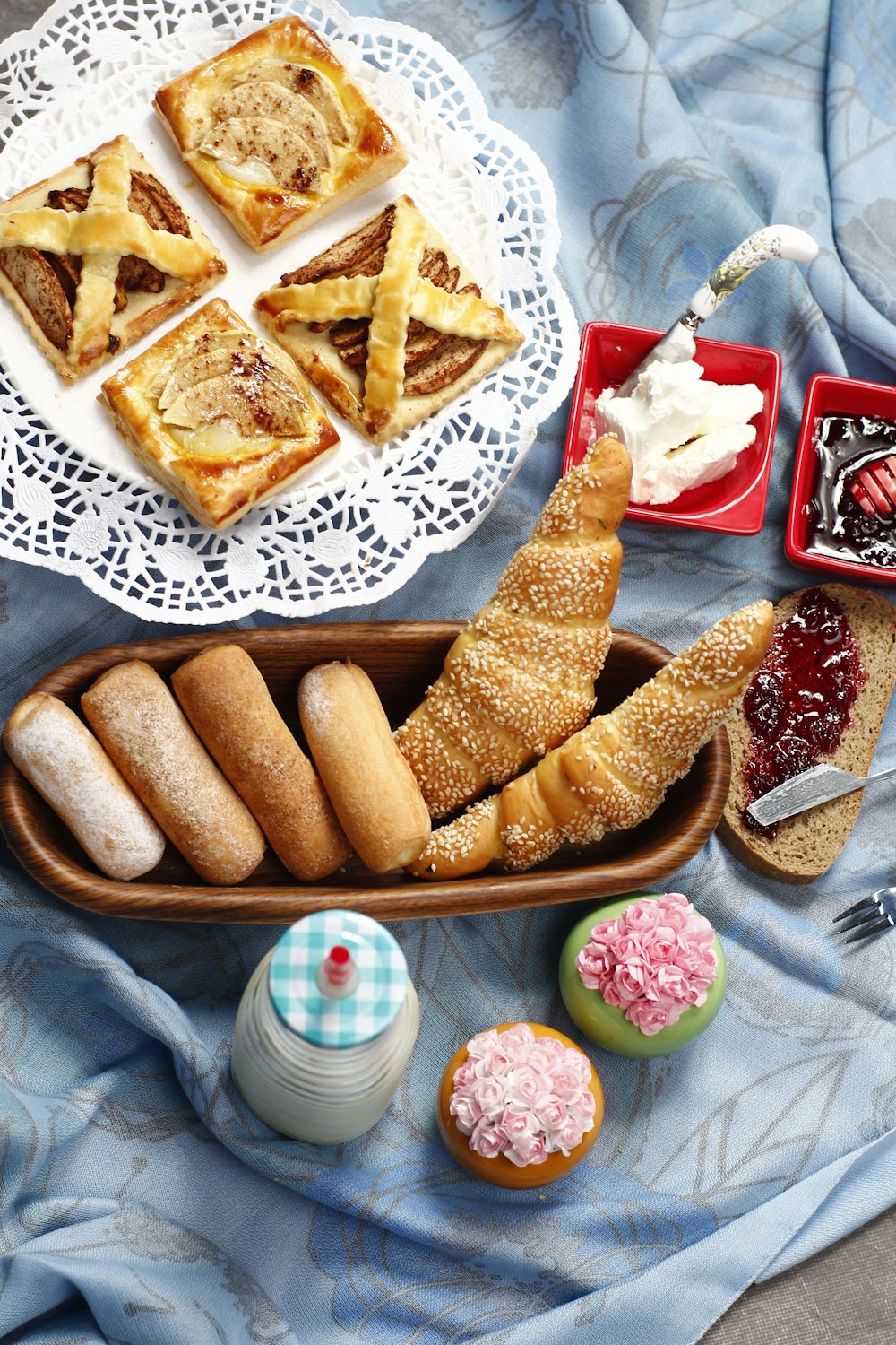 tray of breads and plate of pizza