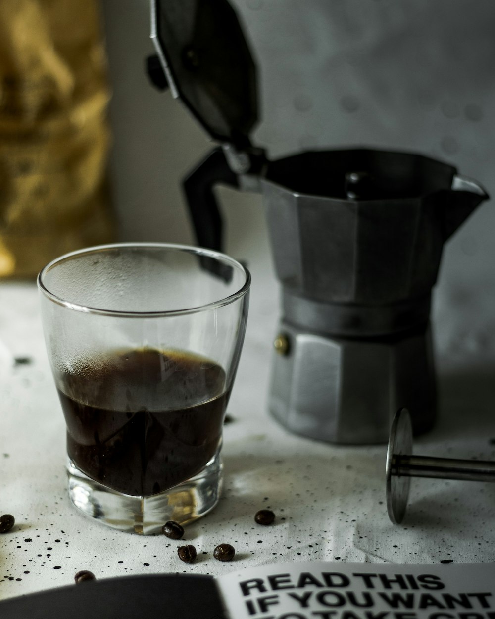 silver moka pot near glass mug