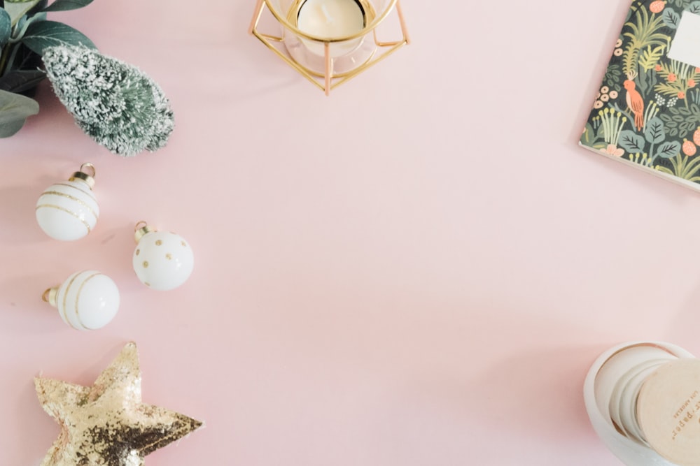 a pink table topped with a star shaped candle and other decorations