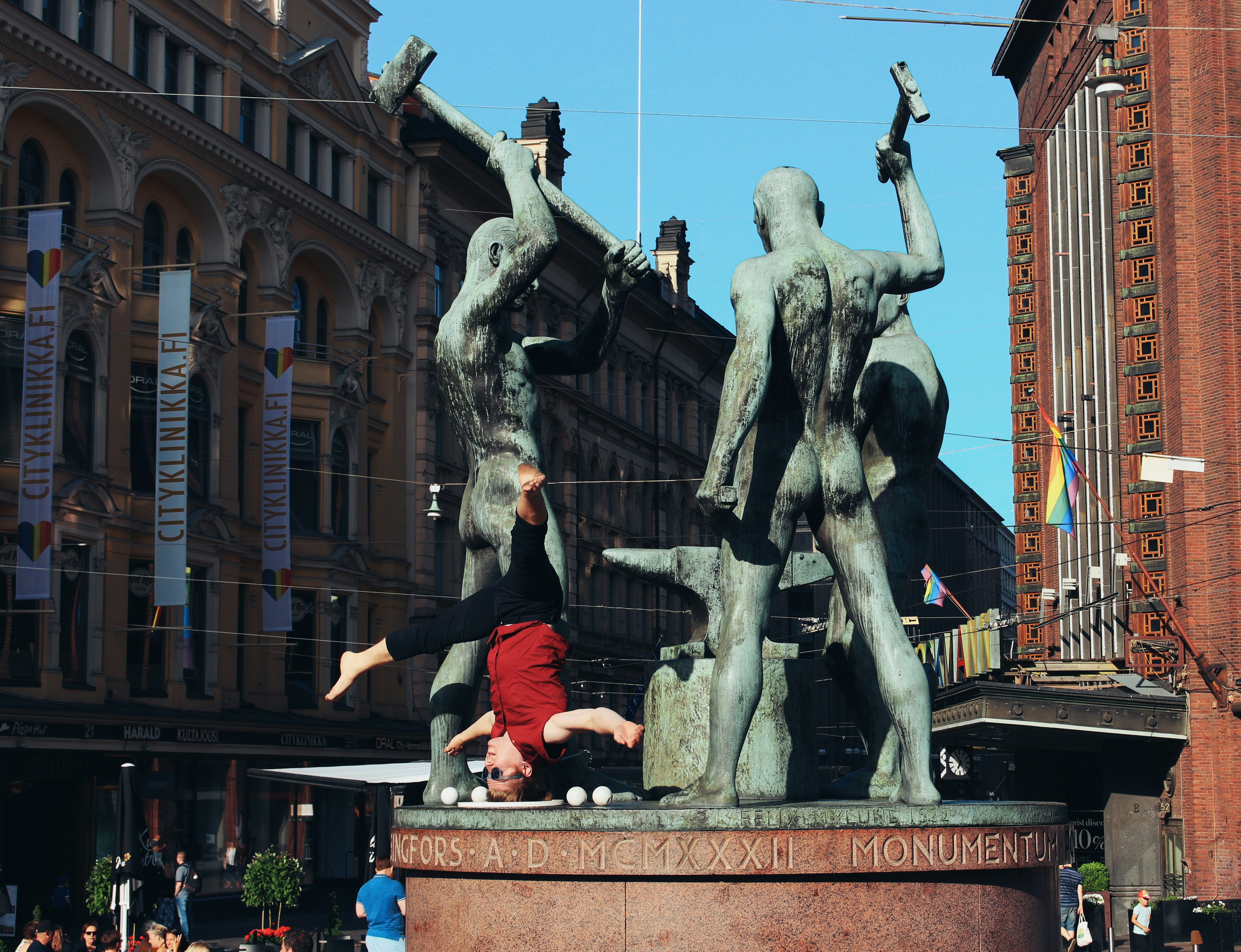 a person doing a handstand in front of a statue