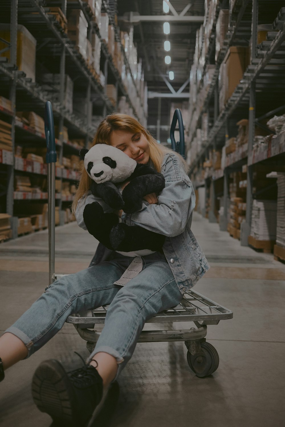 woman hugging panda plush toy