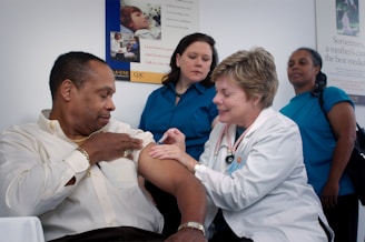 elderly man receiving an injection by his nurse