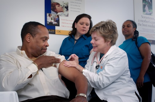 elderly man receiving an injection by his nurse