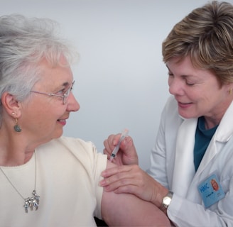 woman inject a woman on left shoulder