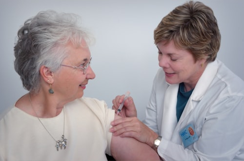Caregiver holding hands with a senior woman, smiling