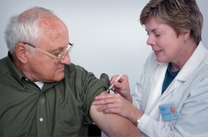 woman injecting syringe on mans arm