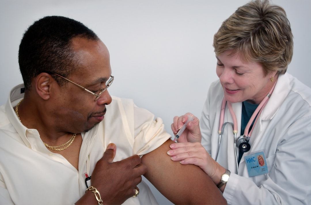 This 2006 image depicted a nurse, who was administering an intramuscular vaccination into a middle-aged man’s left shoulder muscle. The nurse was using her left hand to stabilize the injection site.