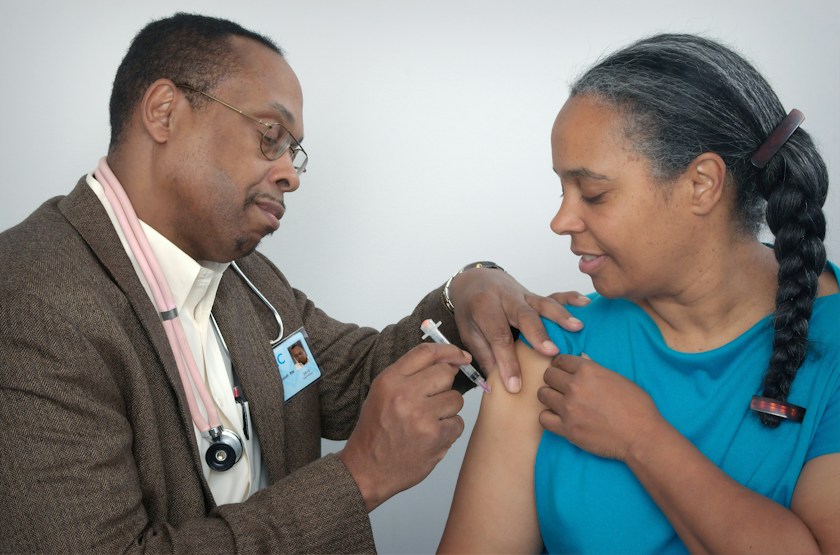 A healthcare professional giving an immunization injection