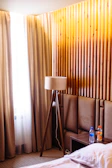 A cozy futon setup with warm lighting and oil bottles arranged neatly nearby.