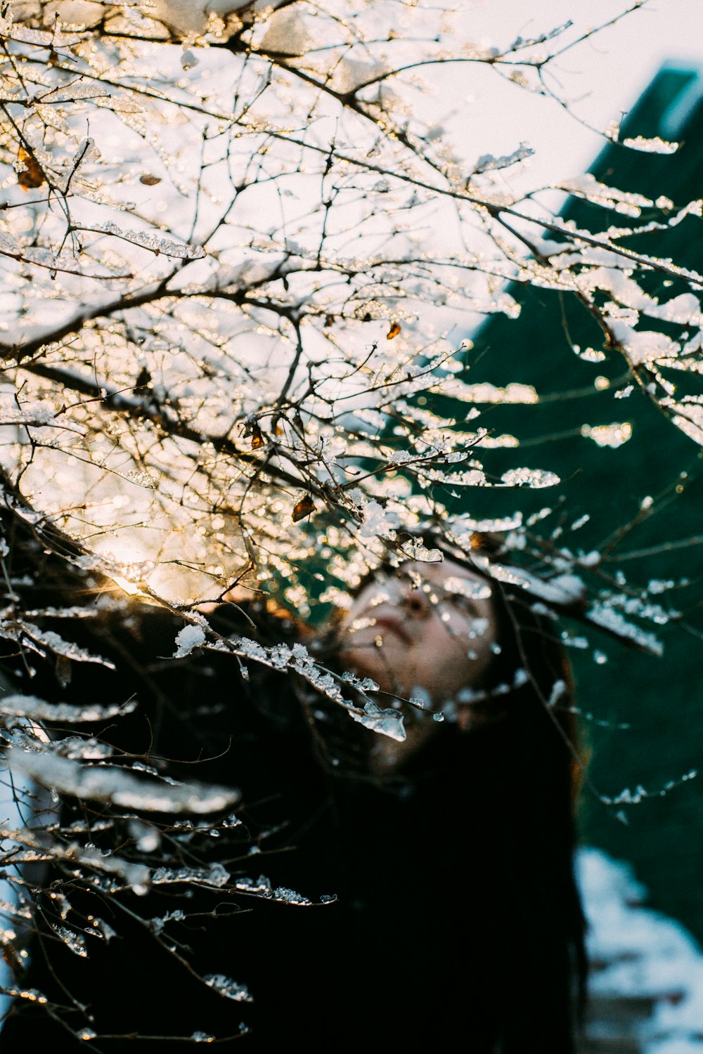 a woman standing in the water with her eyes closed