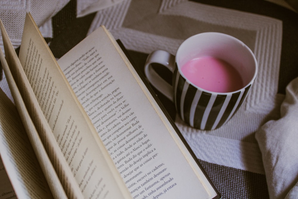 filled mug beside book